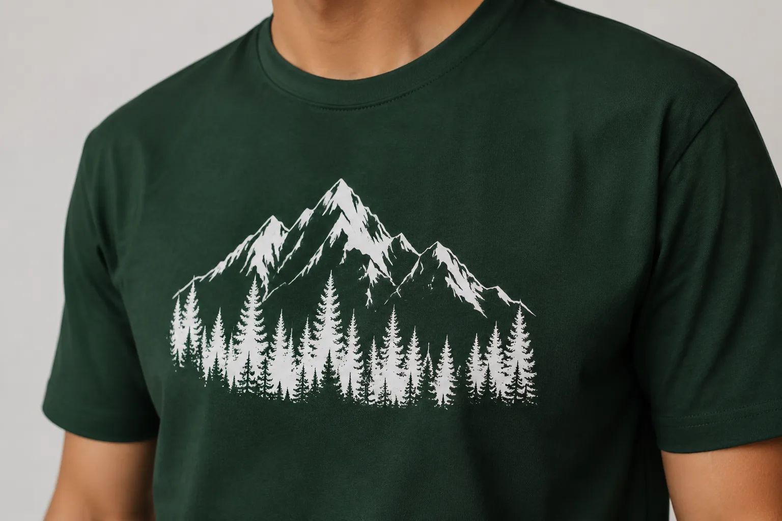 Simulated close view of artwork placement and contrast on a dark green shirt
